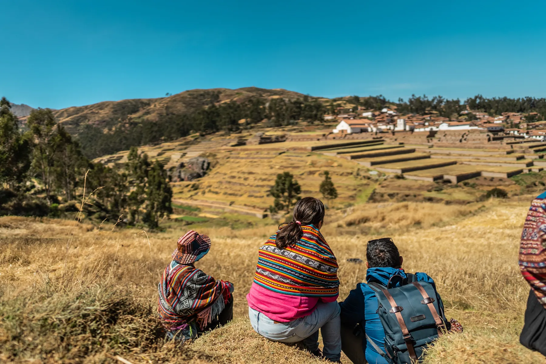 A group of people looking out across a mountain valley.